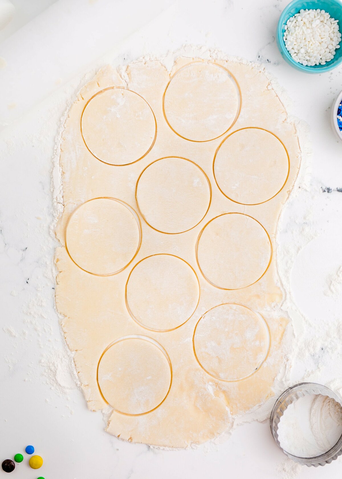 picture of circles cut into cookie dough on a table
