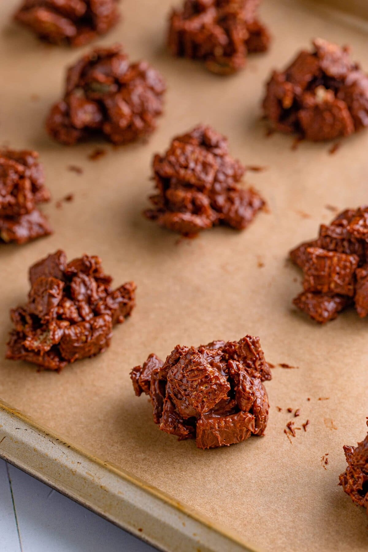 picture of muddy buddy clusters on a baking sheet covered in parchment paper