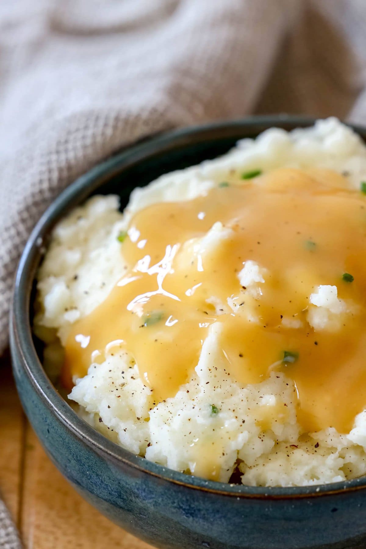 picture of mashed potatoes in a bowl with gravy on top