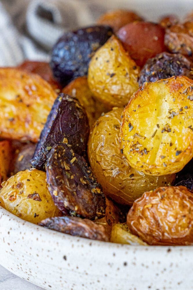 picture of crispy herbed potatoes in a white bowl