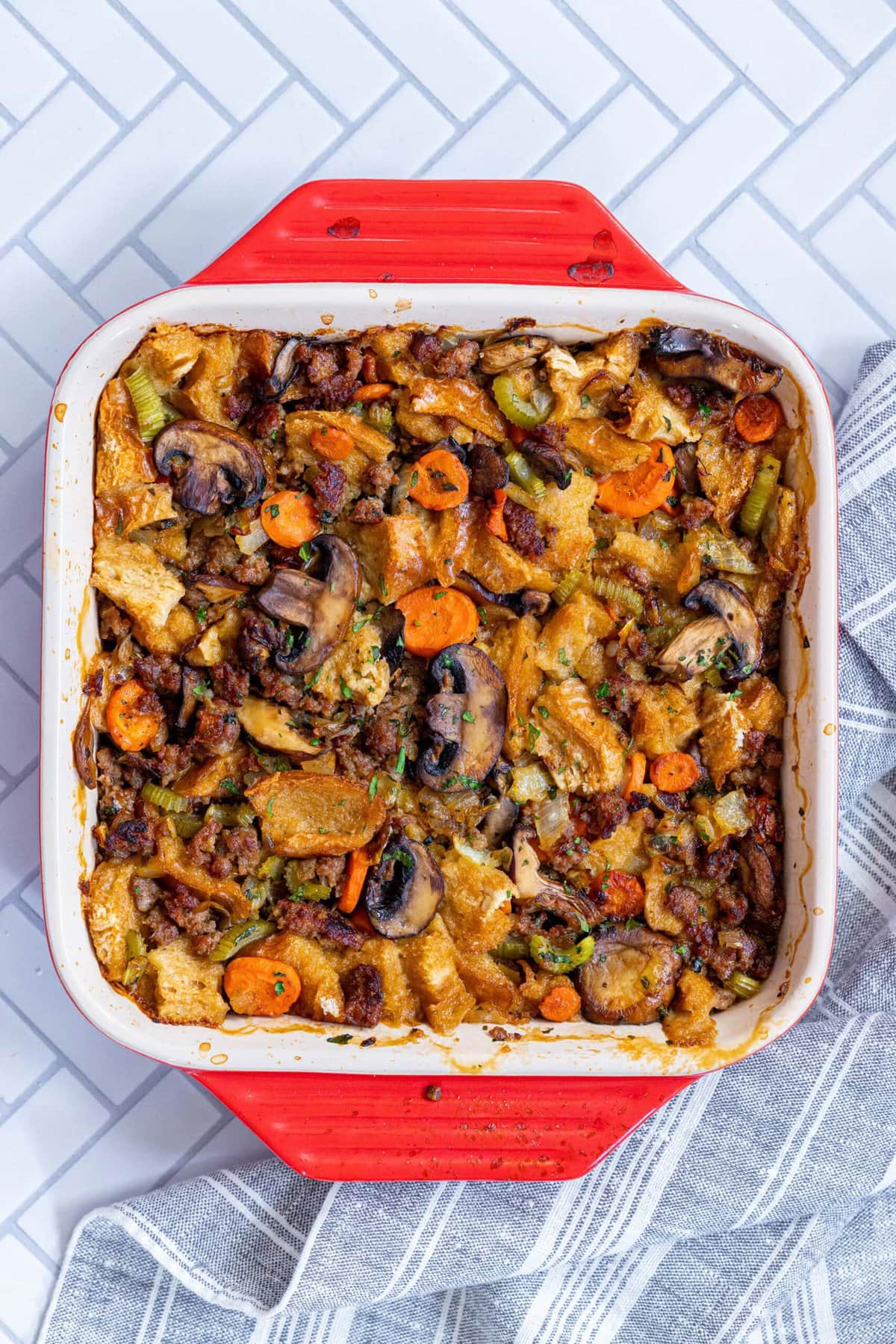 A delightful casserole dish with vegetables and meat, featuring a garlic butter sausage and mushroom stuffing recipe.