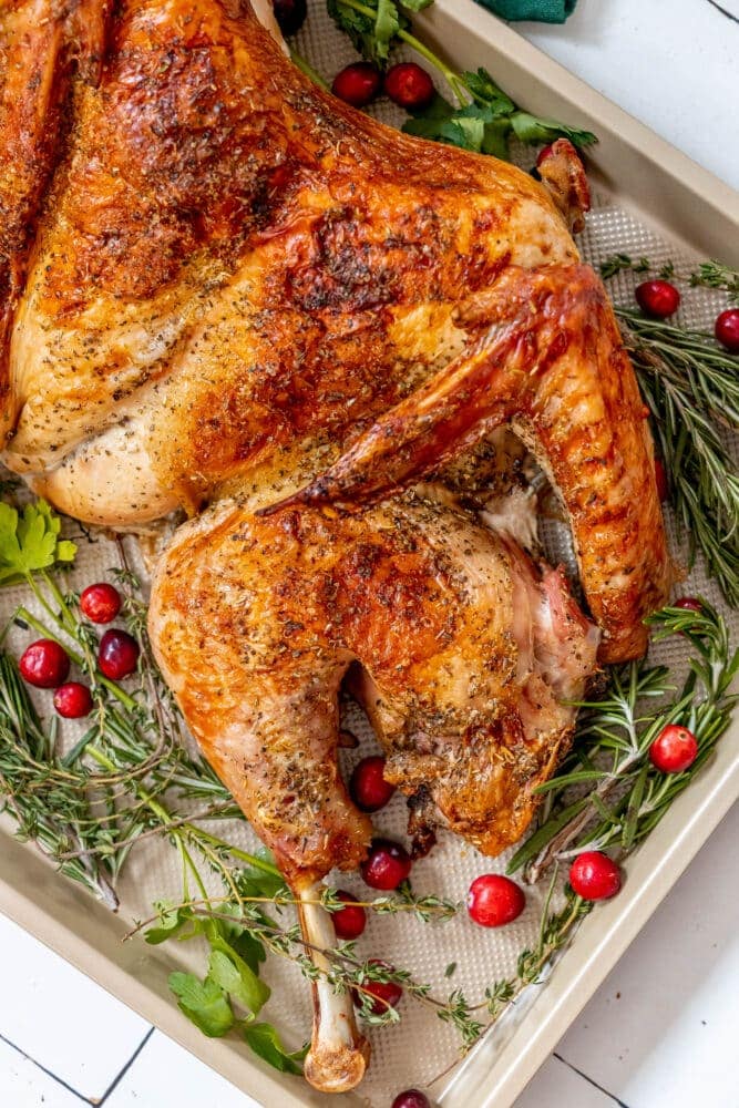 picture of a spatchcocked baked turkey on a baking sheet