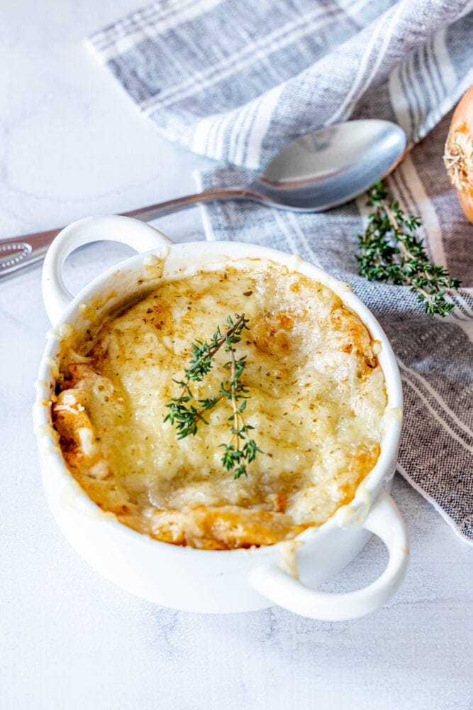 picture of french onion soup topped with melted cheese in a bowl 