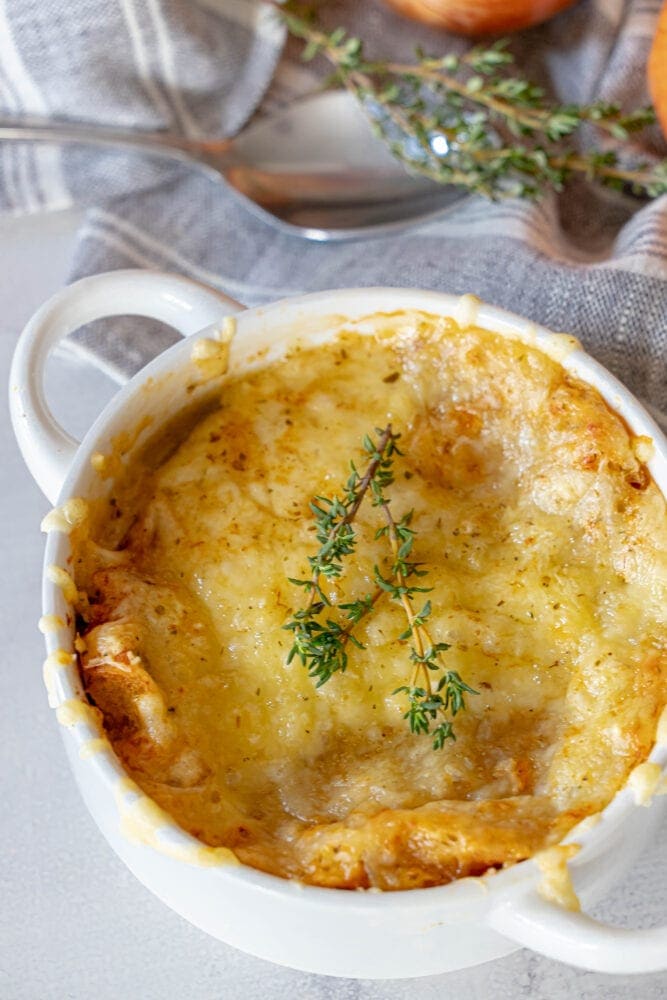 picture of french onion soup topped with melted cheese in a bowl 