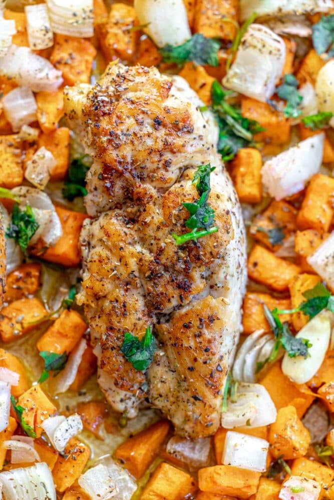 picture of turkey tenderloin on a sheet pan with sweet potatoes and onions