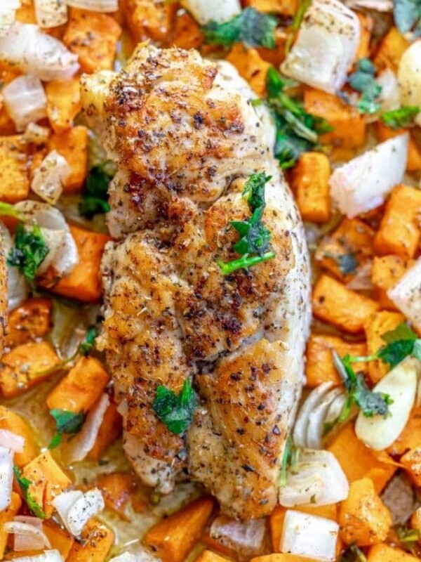 picture of turkey tenderloin on baking sheet with sweet potatoes and onions