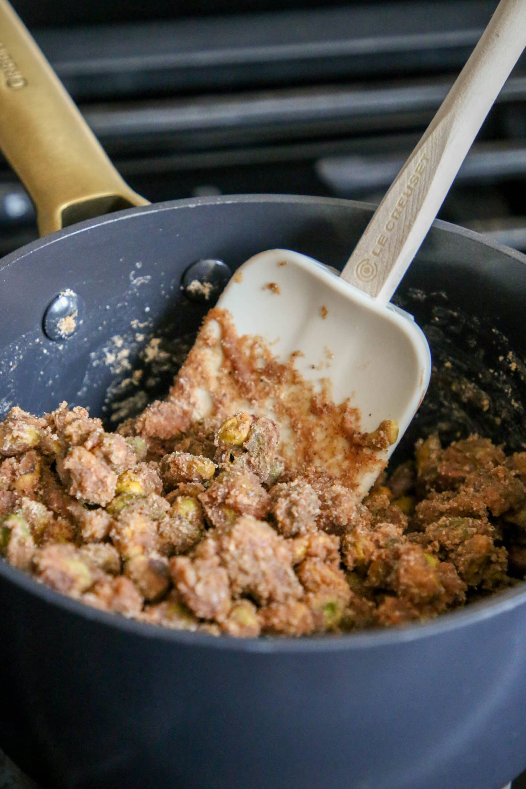 picture of pistachios being stirred into candy mixture