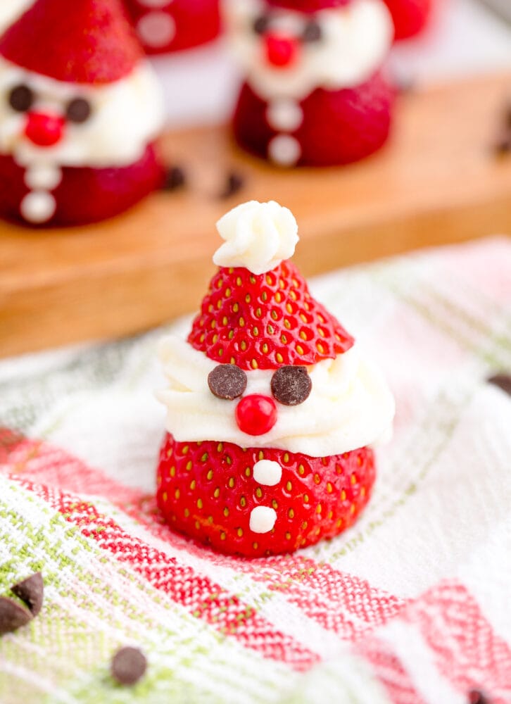 strawberry sliced and topped with whipped cream and chocolate chips to look like santa