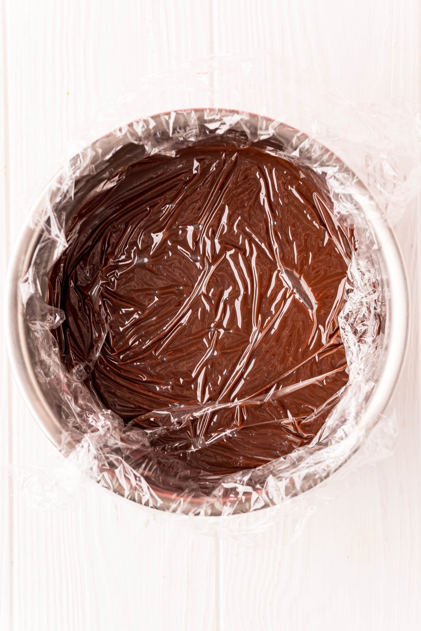 picture of melted chocolate in a bowl with plastic wrap