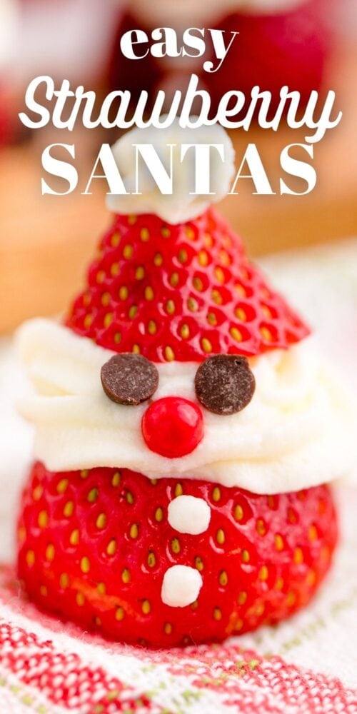 picture of strawberry sliced and topped with whipped cream and chocolate chips to look like santa