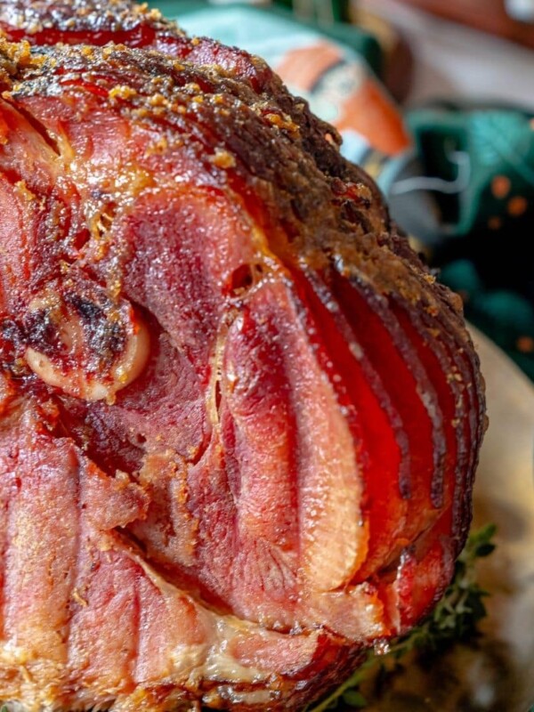 A homemade Honey Baked Ham is sitting on top of a plate.
