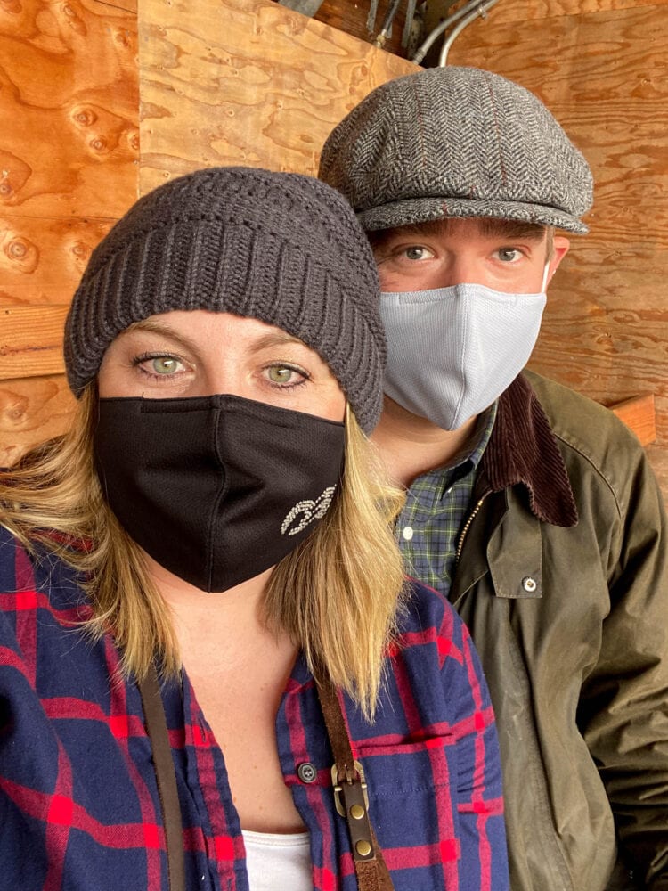 picture of a man and woman in facemasks at the great alaska lumberjack show in alaska