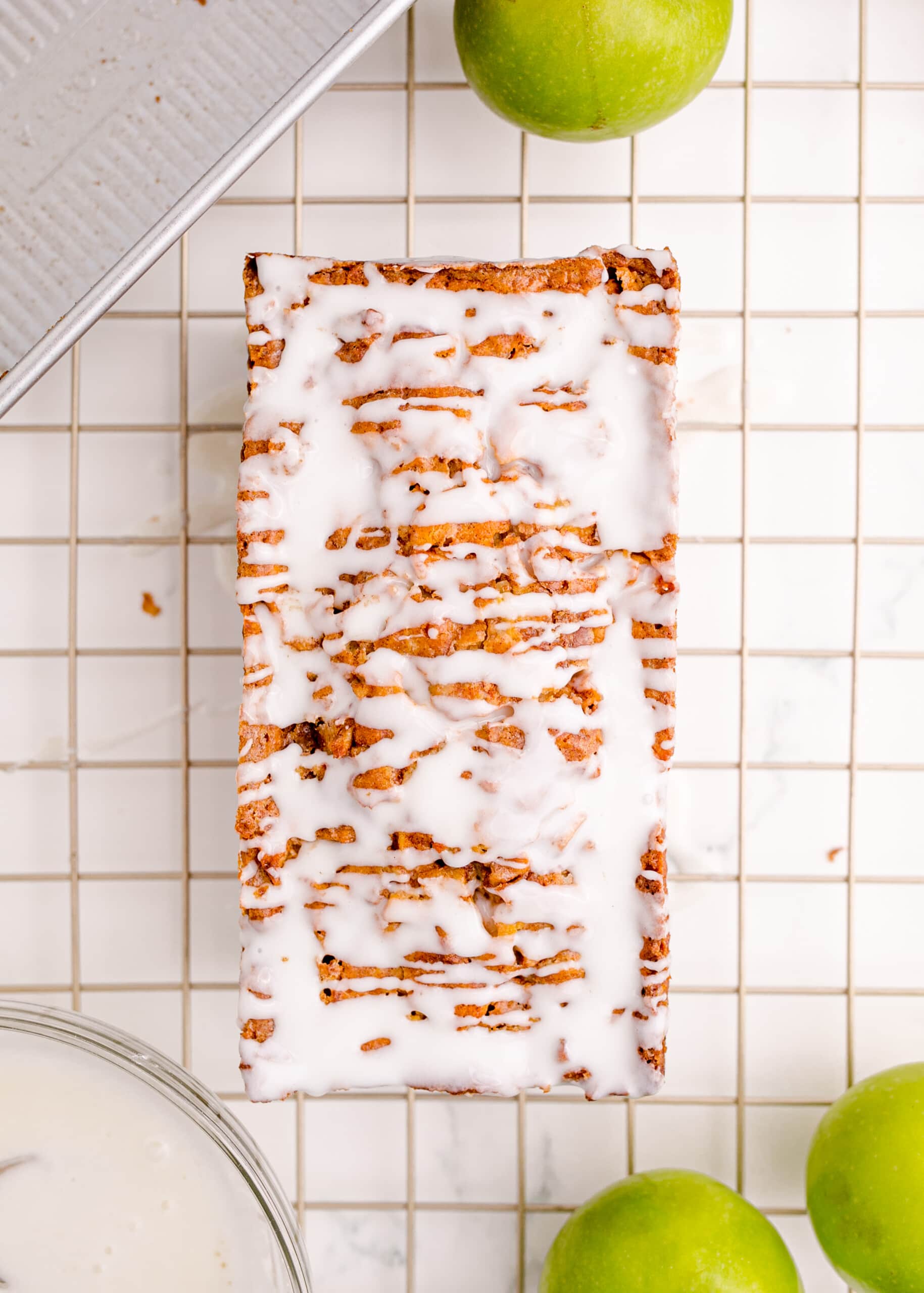 picture of iced apple fritter bread on a cooling rack