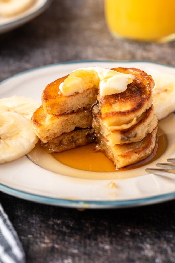 stack of pancakes with a piece taken out of the stack 