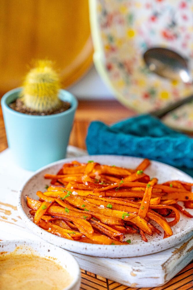 picture of carrot bacon on a plate with chives on and salt top 