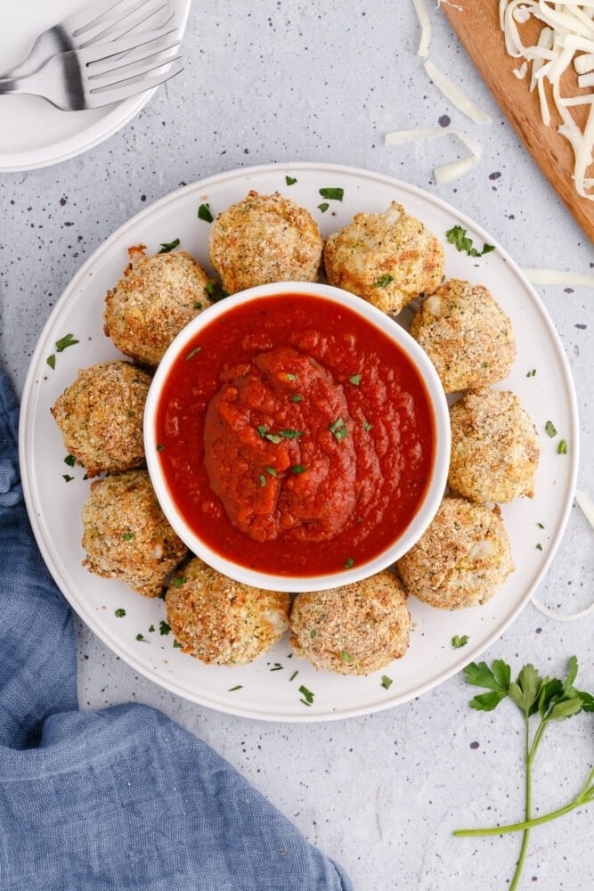 picture of air fryer arancini ball on a plate with sauce