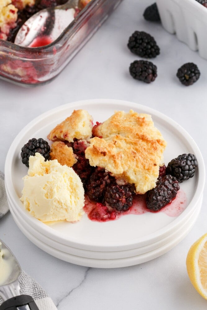 blackberries and crusty topping on a plate with ice cream on it