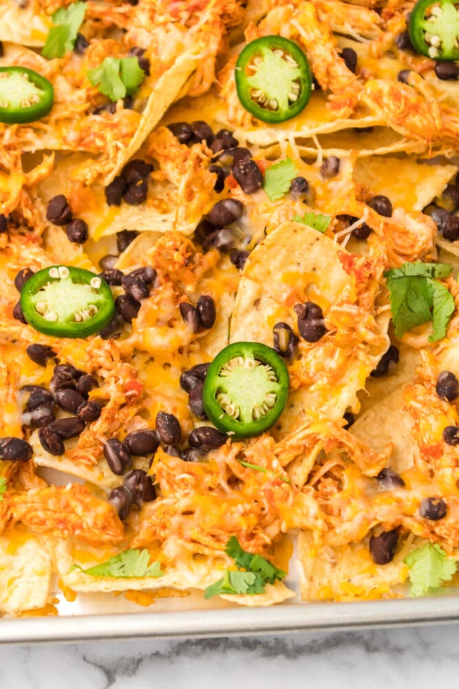 picture of chicken nachos on a baking sheet