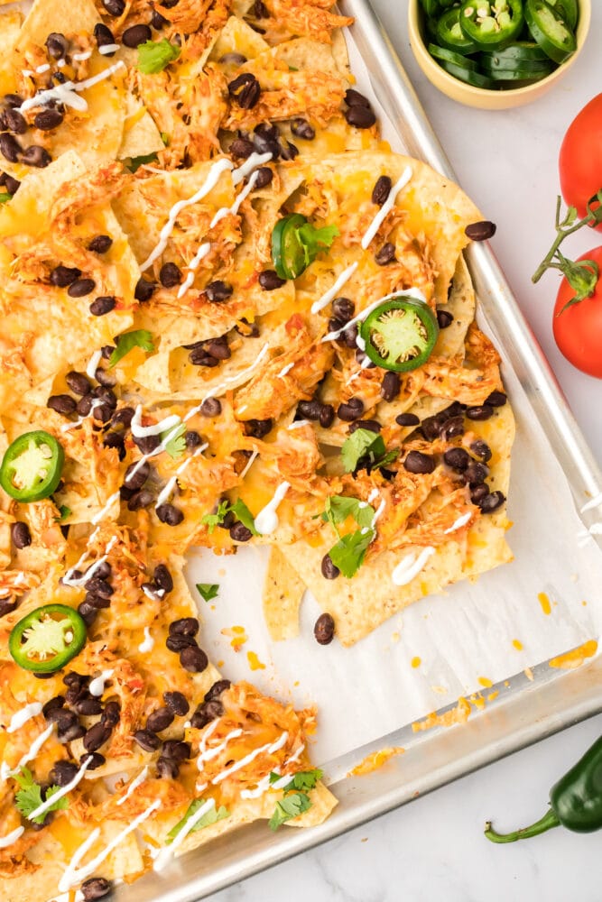 picture of chicken nachos on a baking sheet
