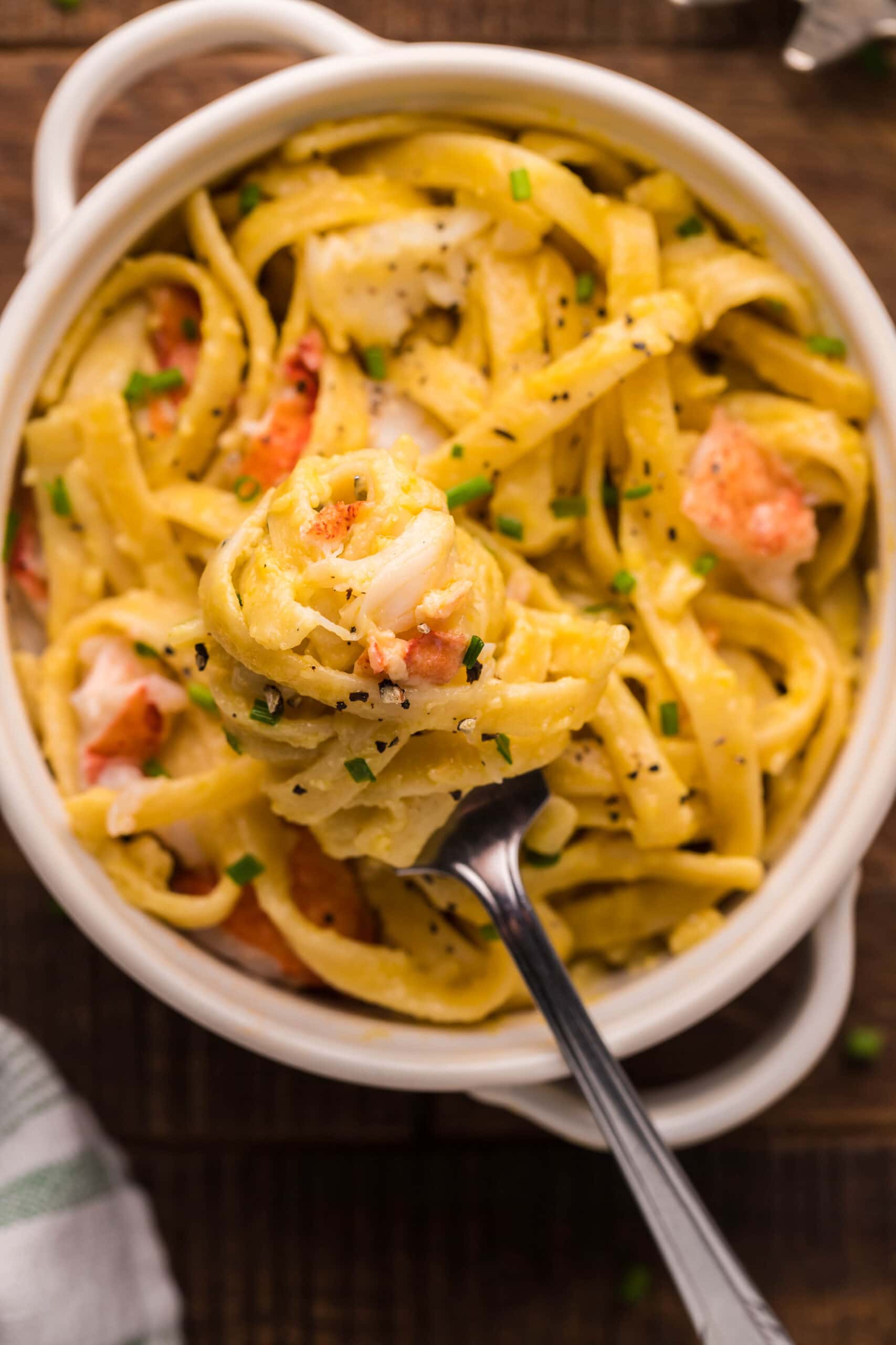 A bowl of Instant Pot pasta with shrimp and peas.