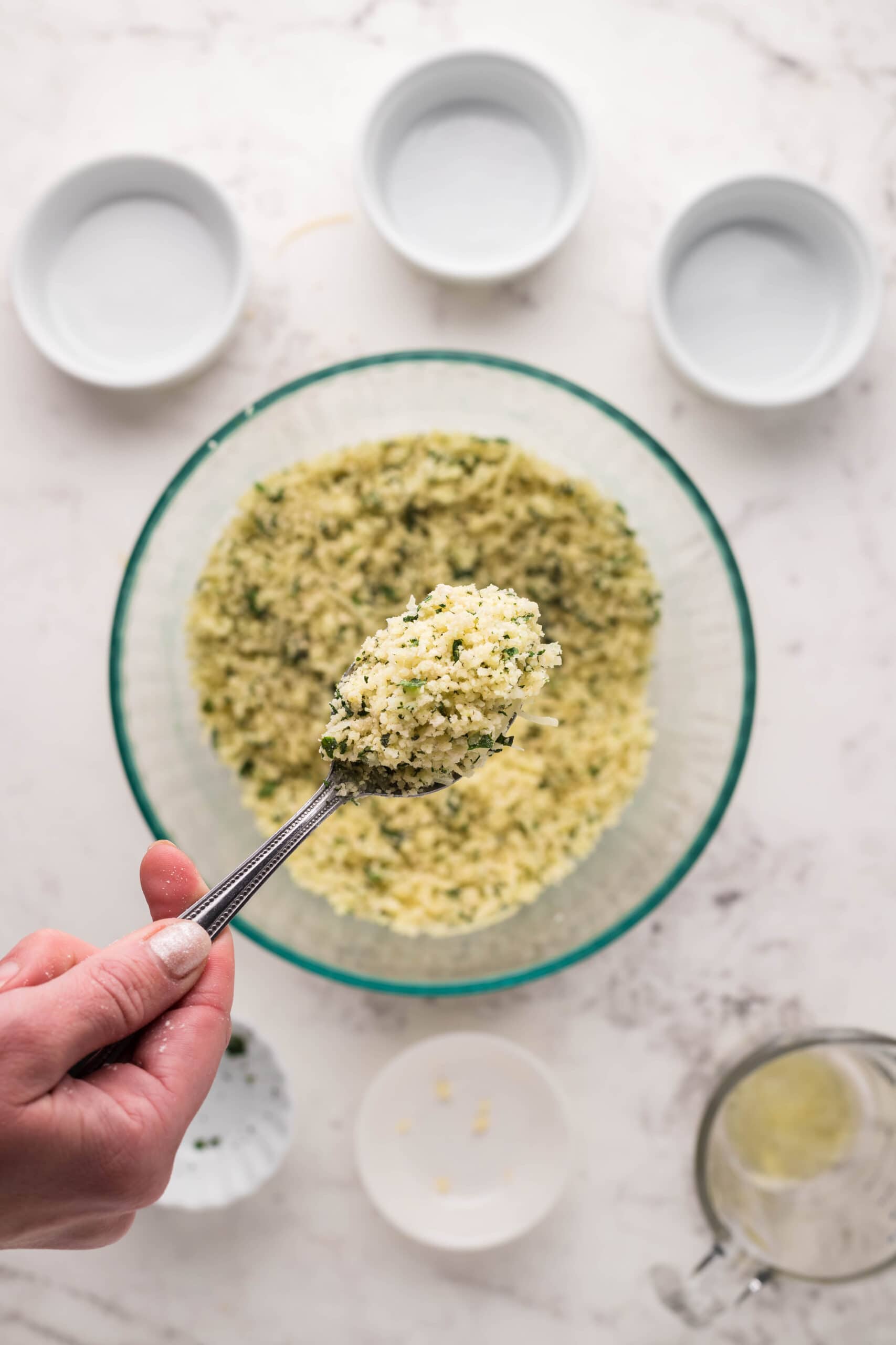 A person pouring parmesan crusted steak into a bowl.