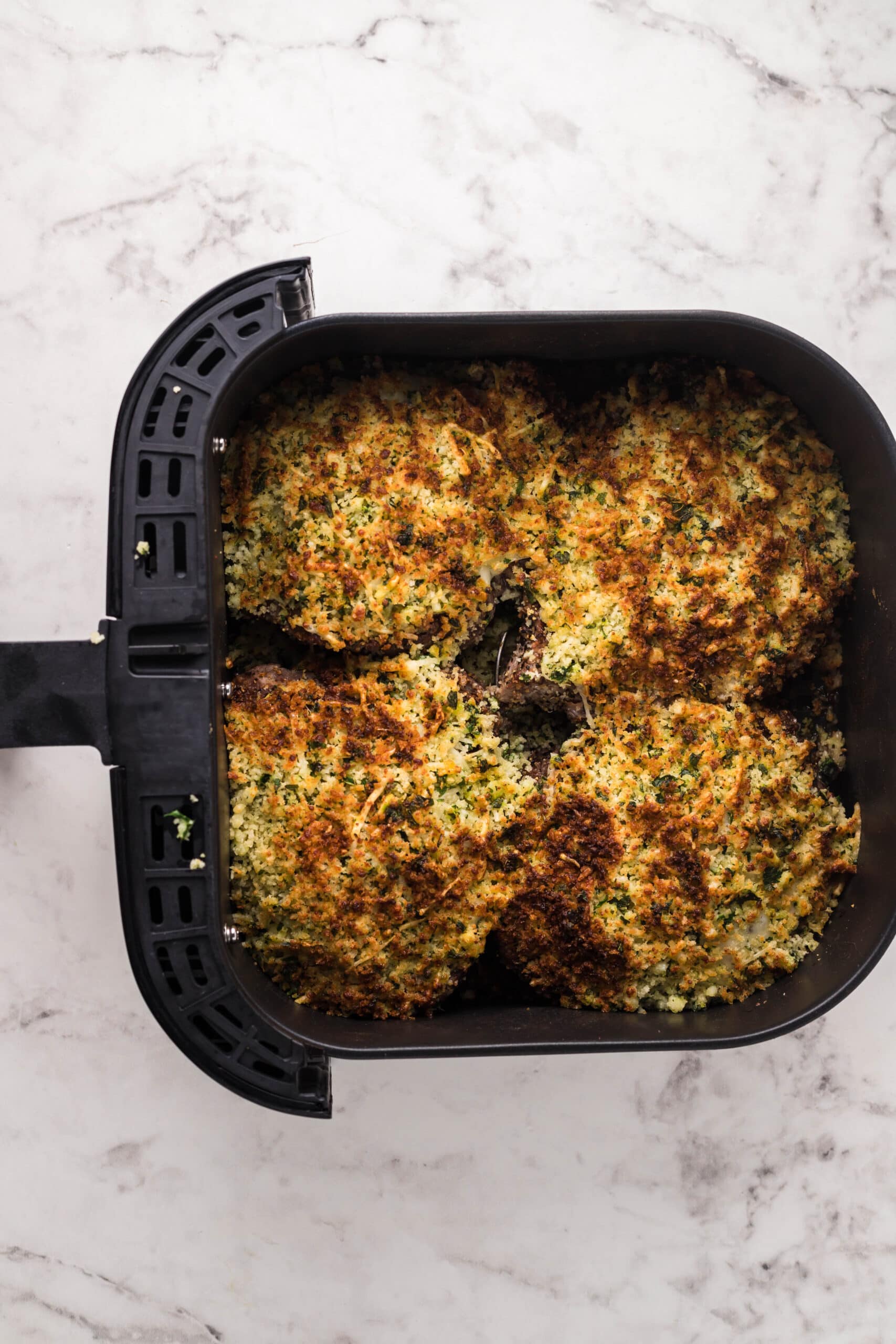 picture of herb breadcrumb topped steaks in an air fryer