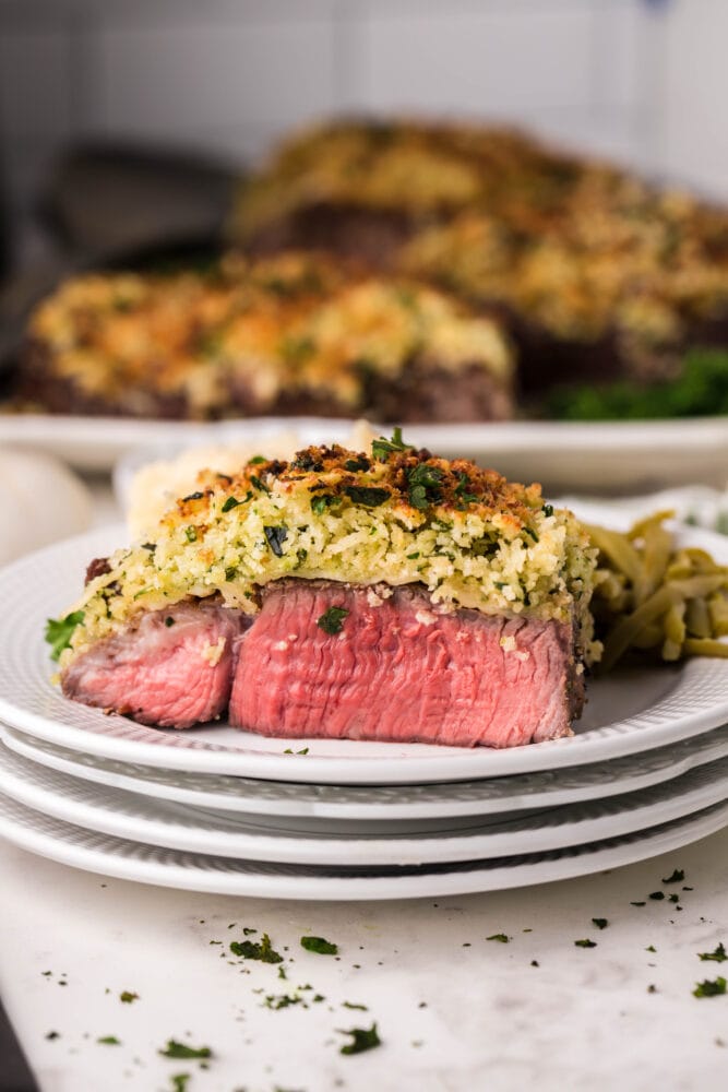 picture of steak with parmesan crust on top on a plate