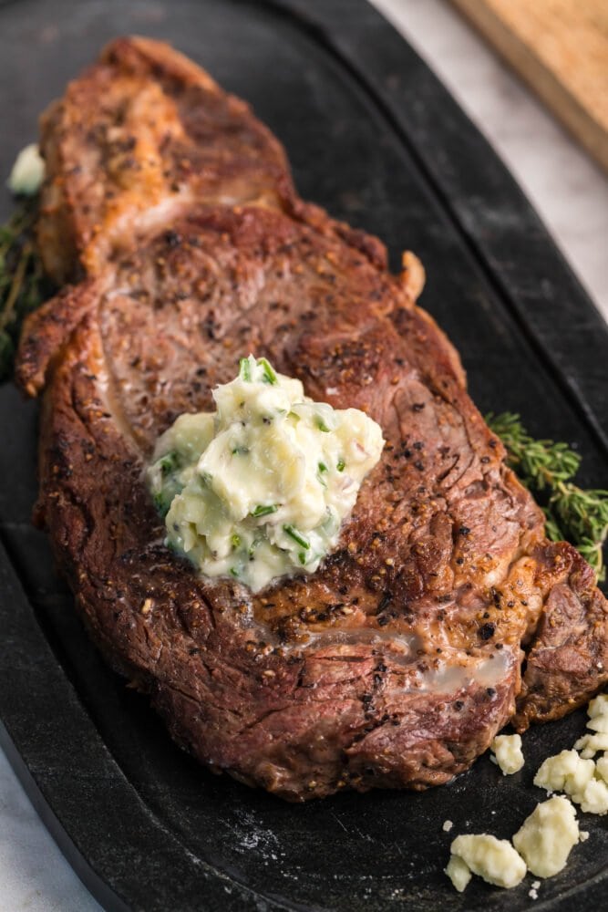 picture of new york strip steak with blue cheese butter on top 