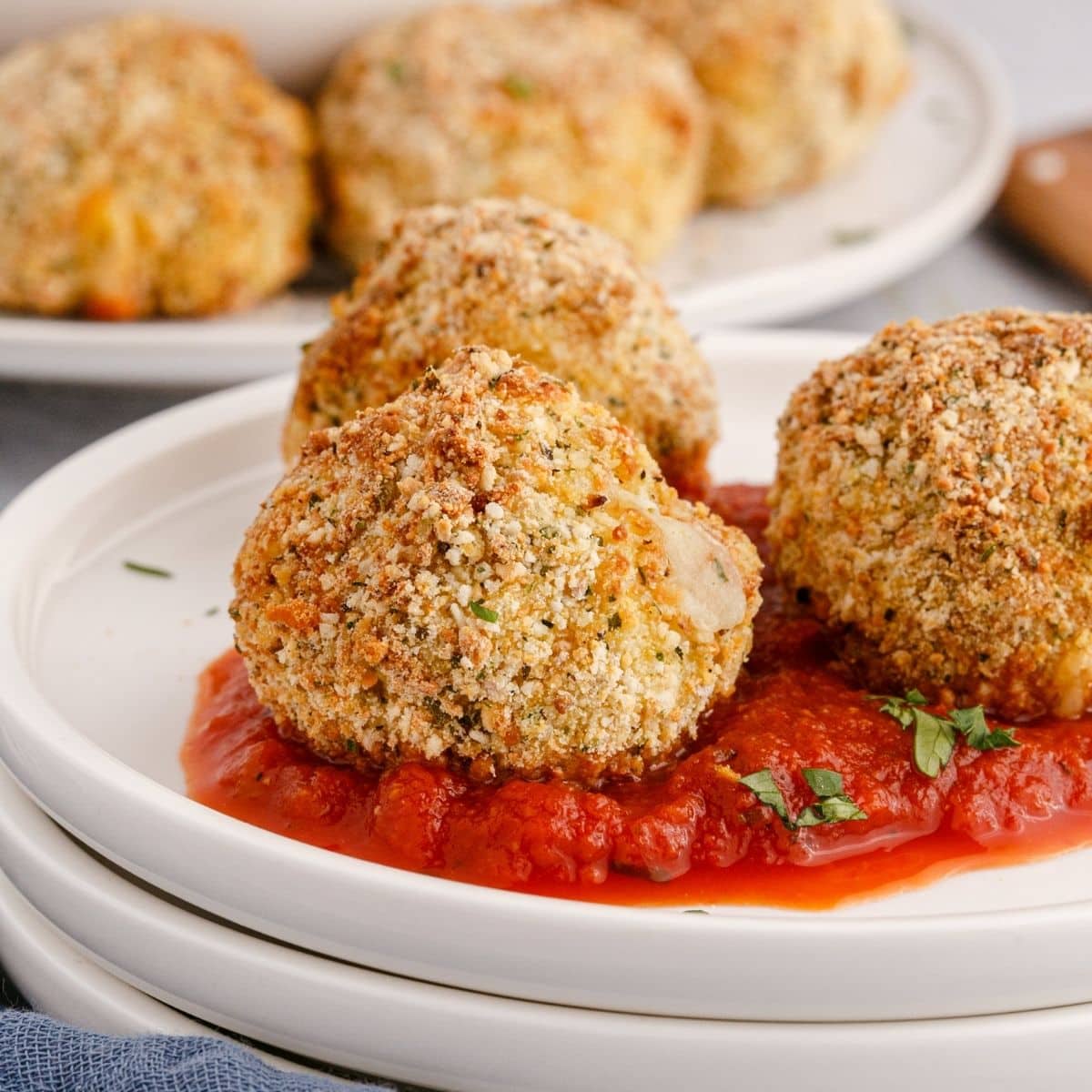 picture of air fryer arancini ball on a plate with sauce