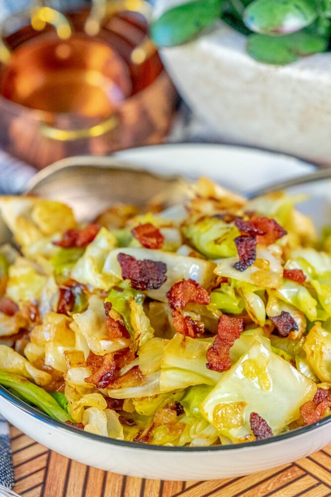 pan fried cabbage and bacon in a white bowl 