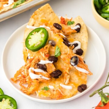 picture of instant pot chicken nachos on a white plate
