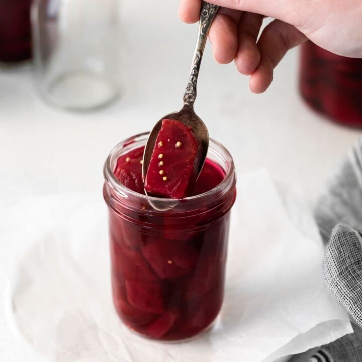 picture of pickled beets in a jar with a spoon