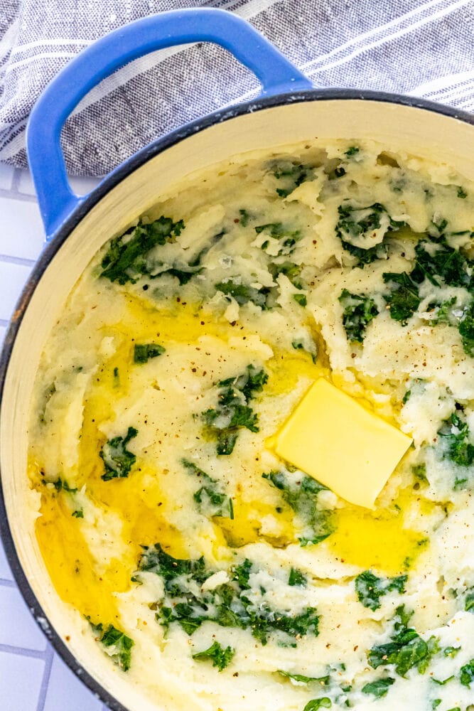 mashed potato and kale irish colcannon in a blue dutch oven