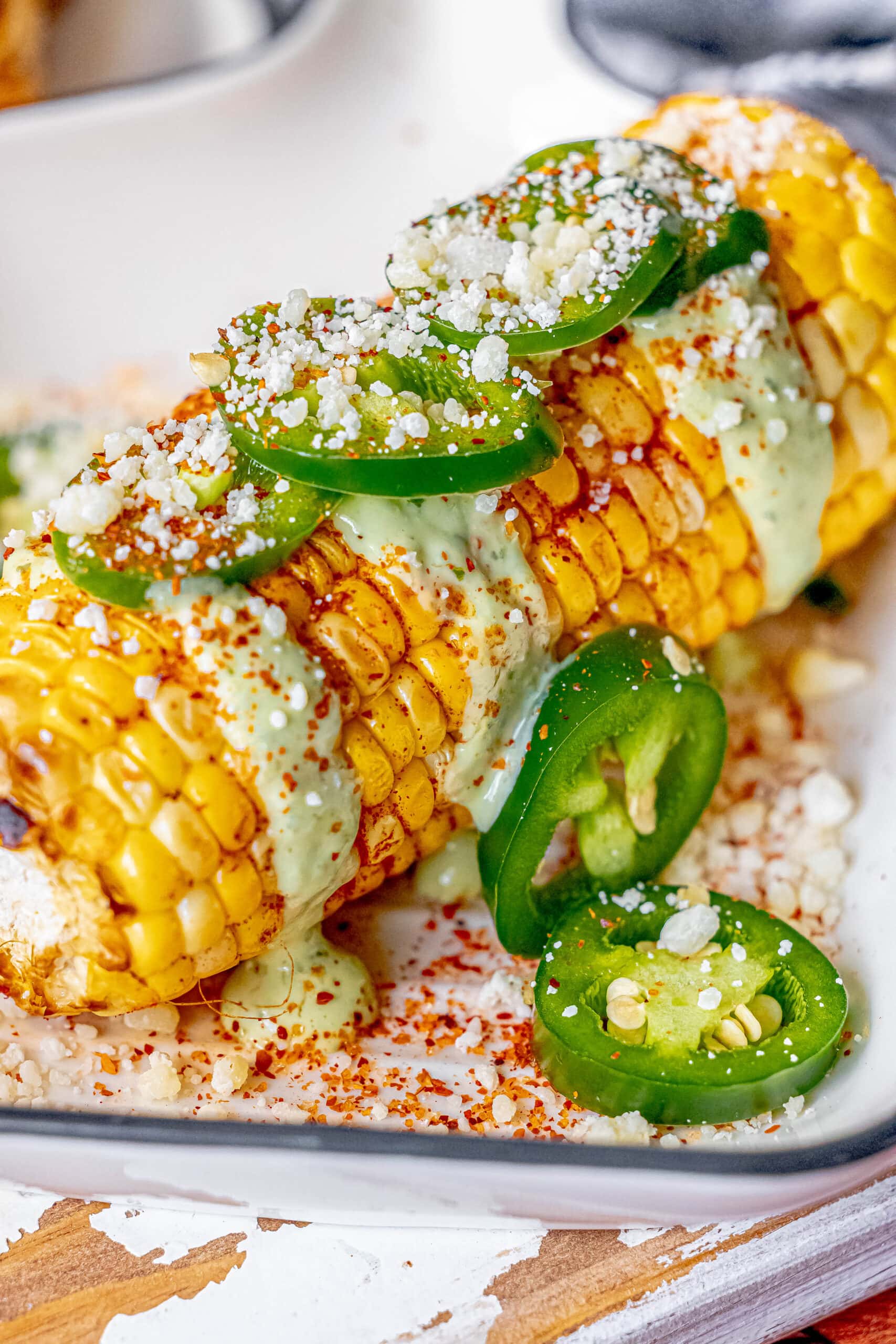 Corn on the cob with jalapenos, salsa, and elotes.