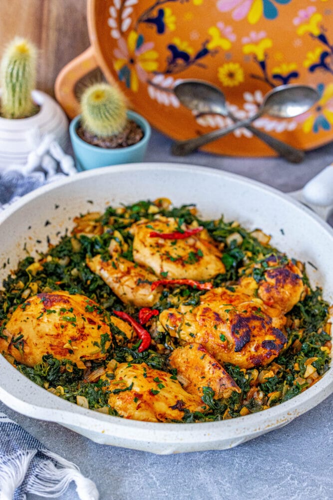 picture of harissa chicken and spinach in a pan 