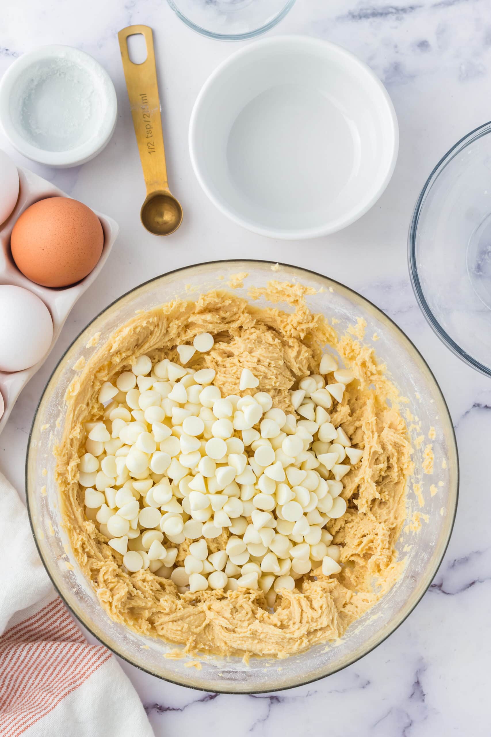 picture of cookie batter and white chocolate chips in a bowl