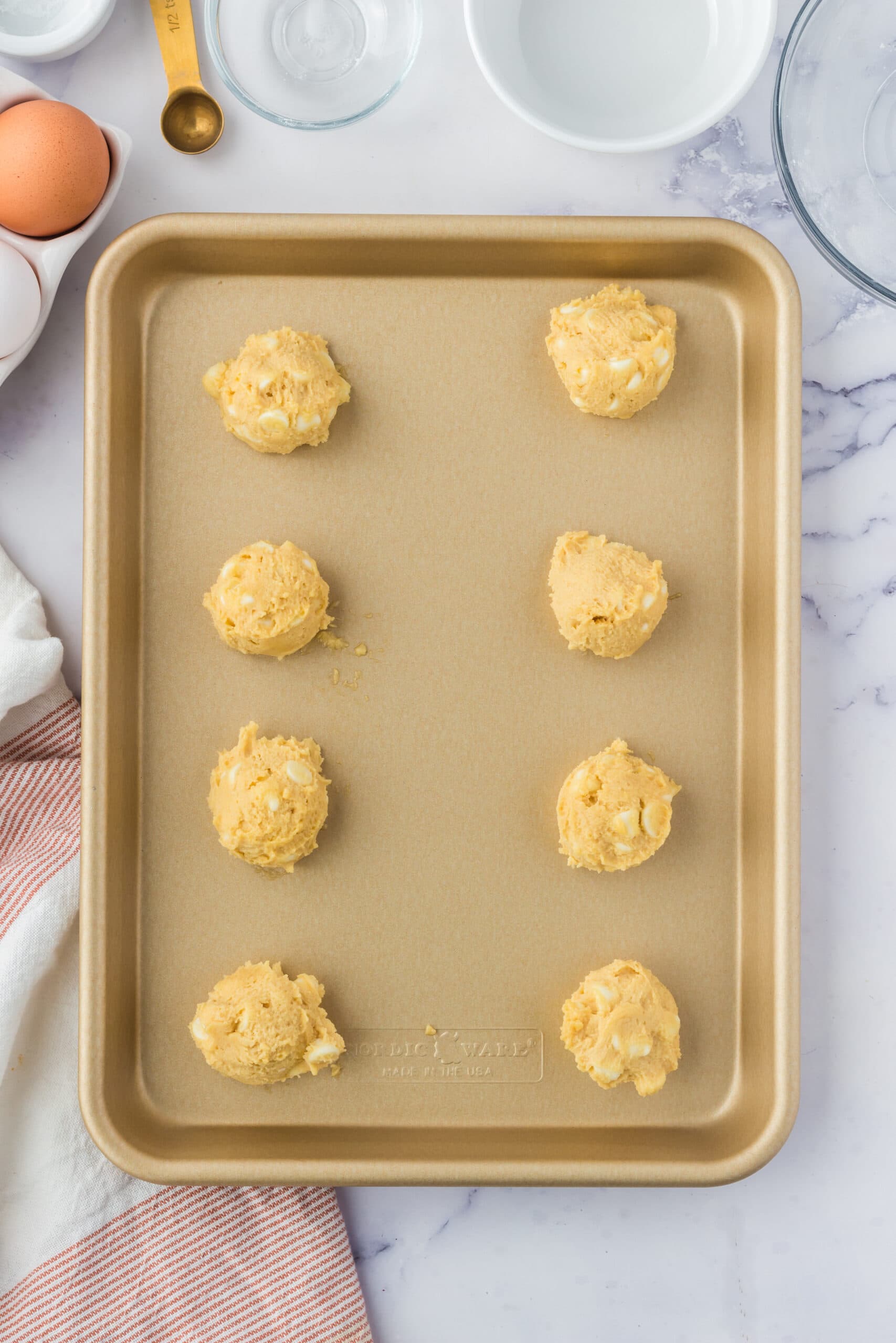 picture of cookie dough balls on a baking sheet