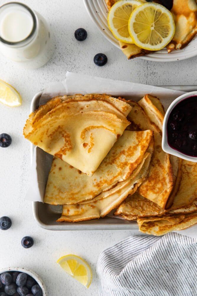 picture of lemon blueberry crepes on a dish with blueberry sauce