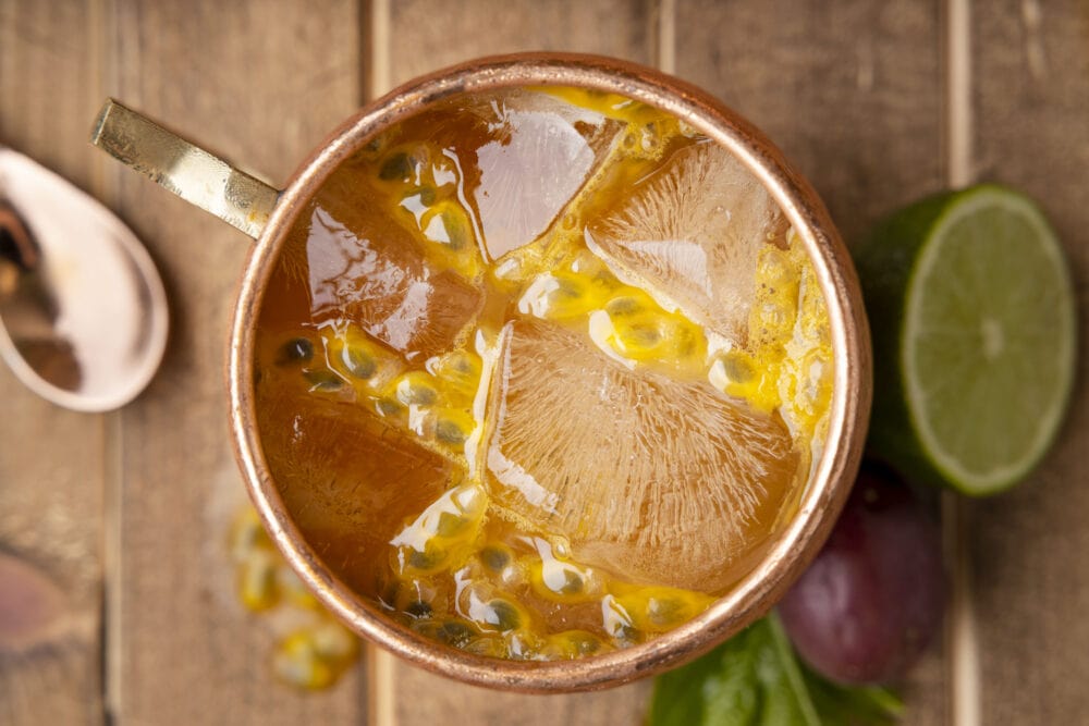 picture of passion fruit dark and stormy in a copper mug