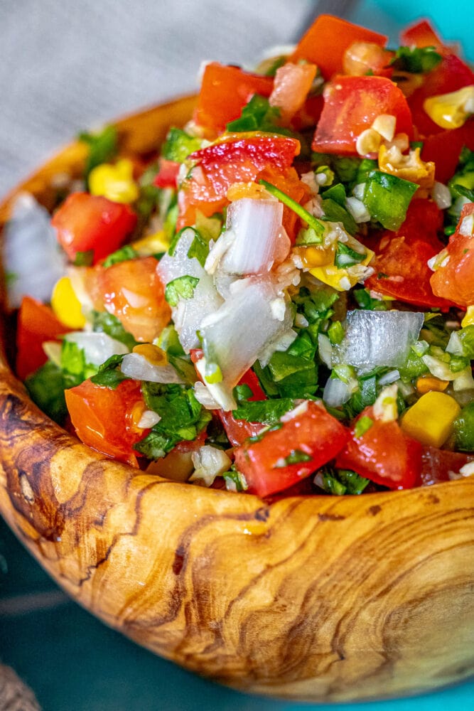 picture of corn pico de gallo in a wooden bowl 