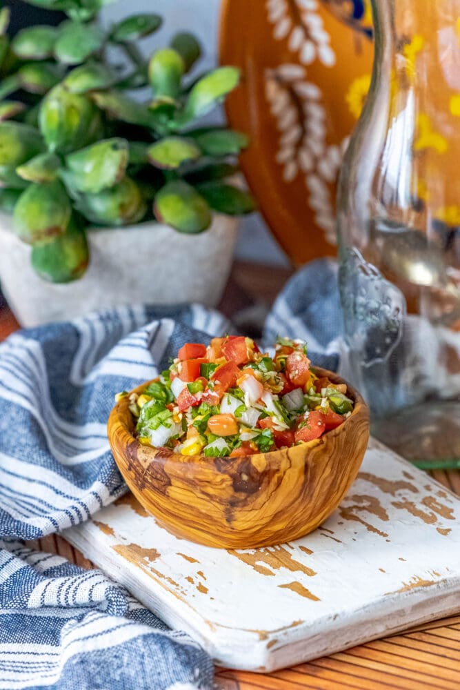 picture of corn pico de gallo in a wooden bowl 
