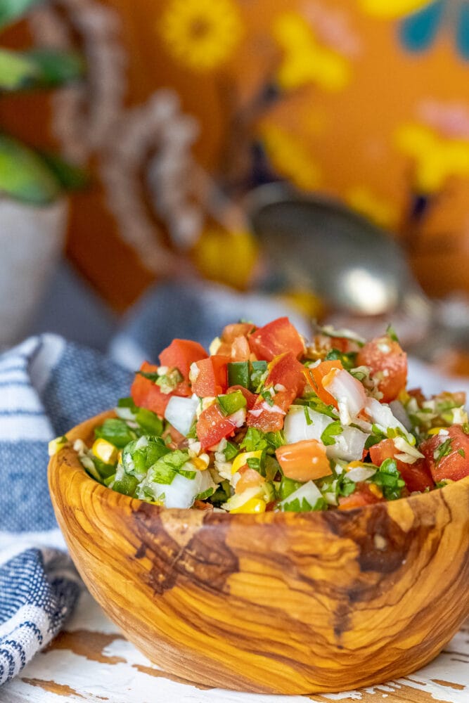 picture of corn pico de gallo in a wooden bowl 