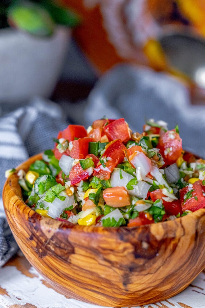 picture of corn pico de gallo in a wooden bowl 