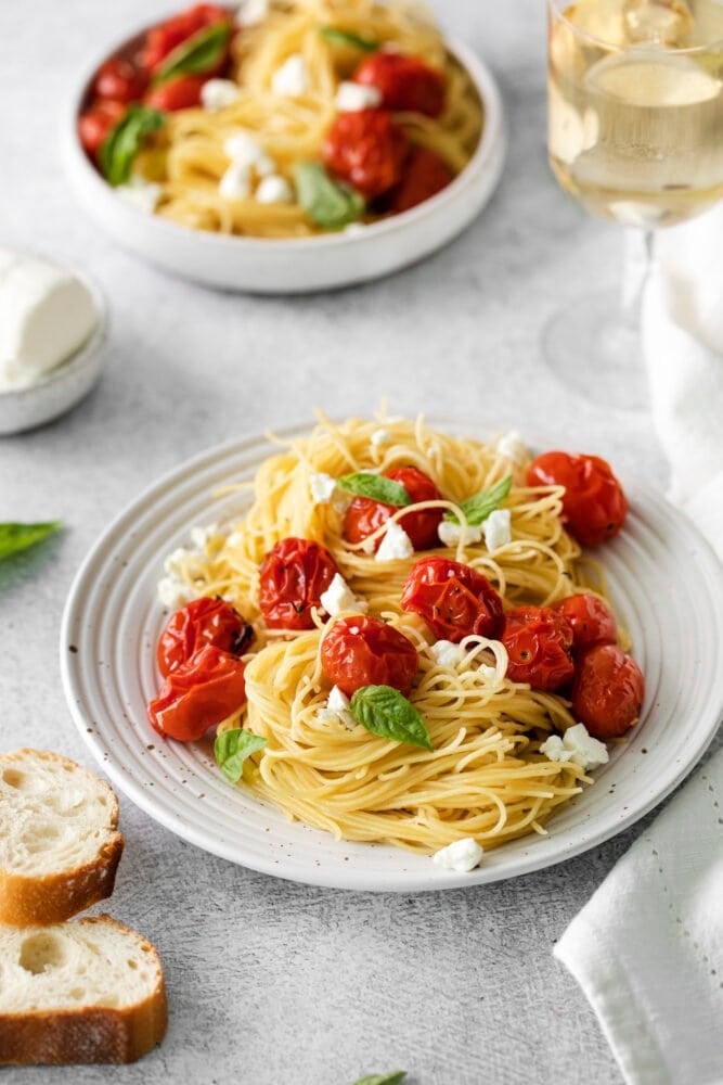 picture of roasted tomato and goat cheese pasta on a white plate
