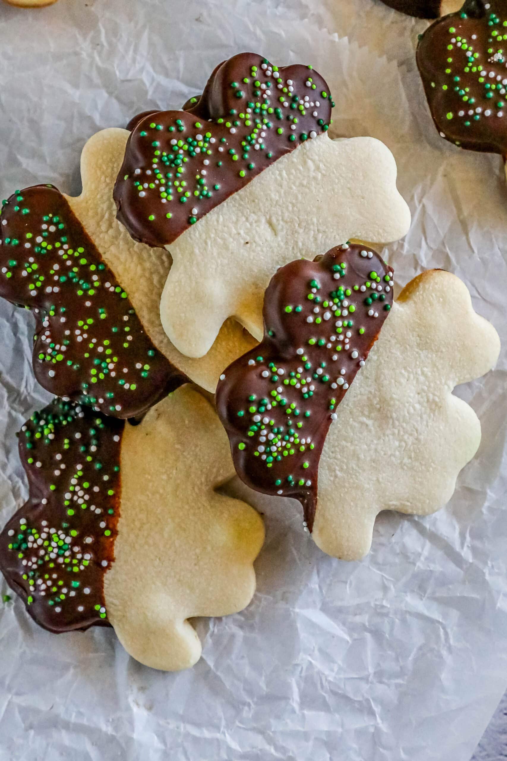 St. Patrick's Day cookies with chocolate and sprinkles in the shape of shamrocks.