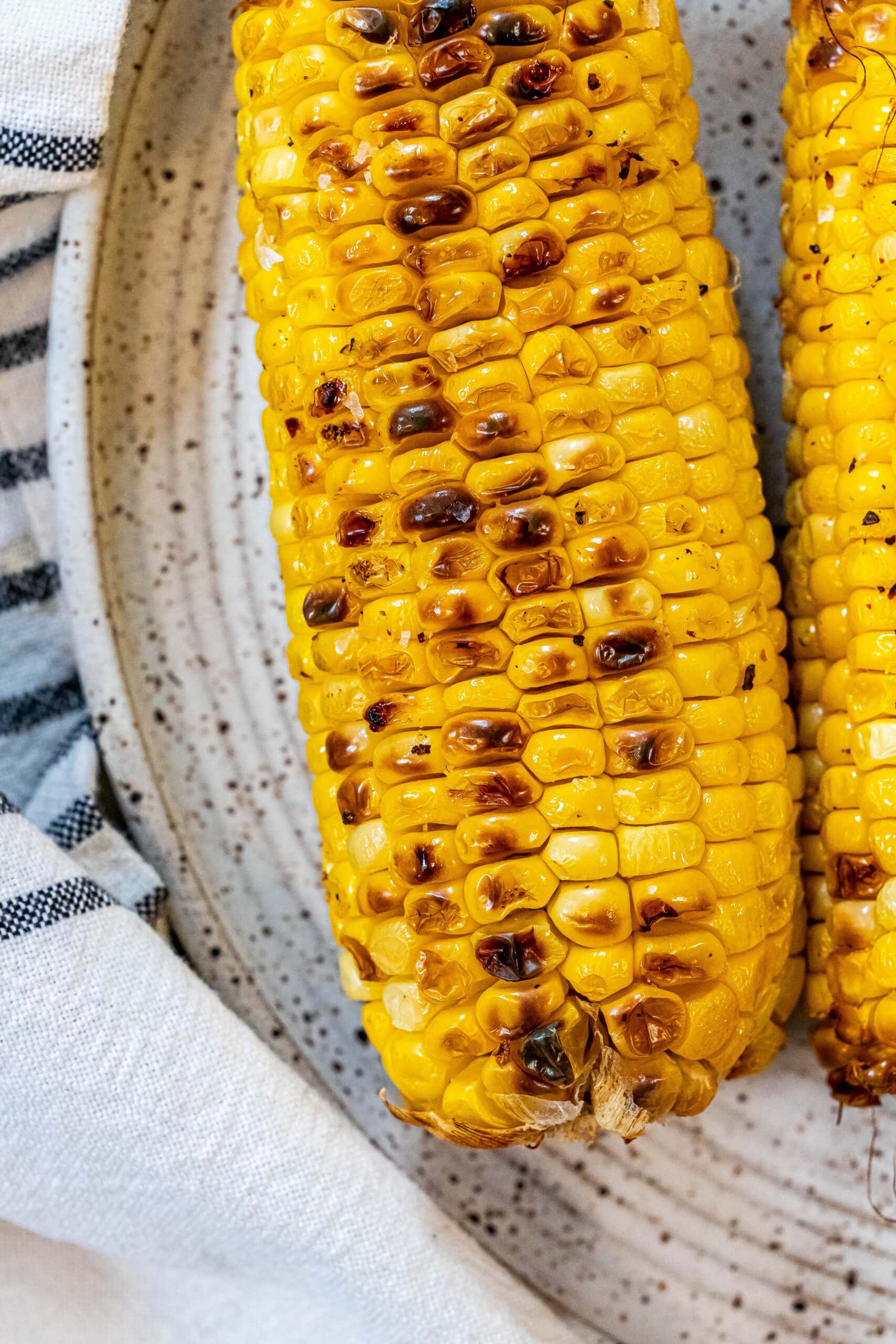 picture of charred corn on the cob on a plate
