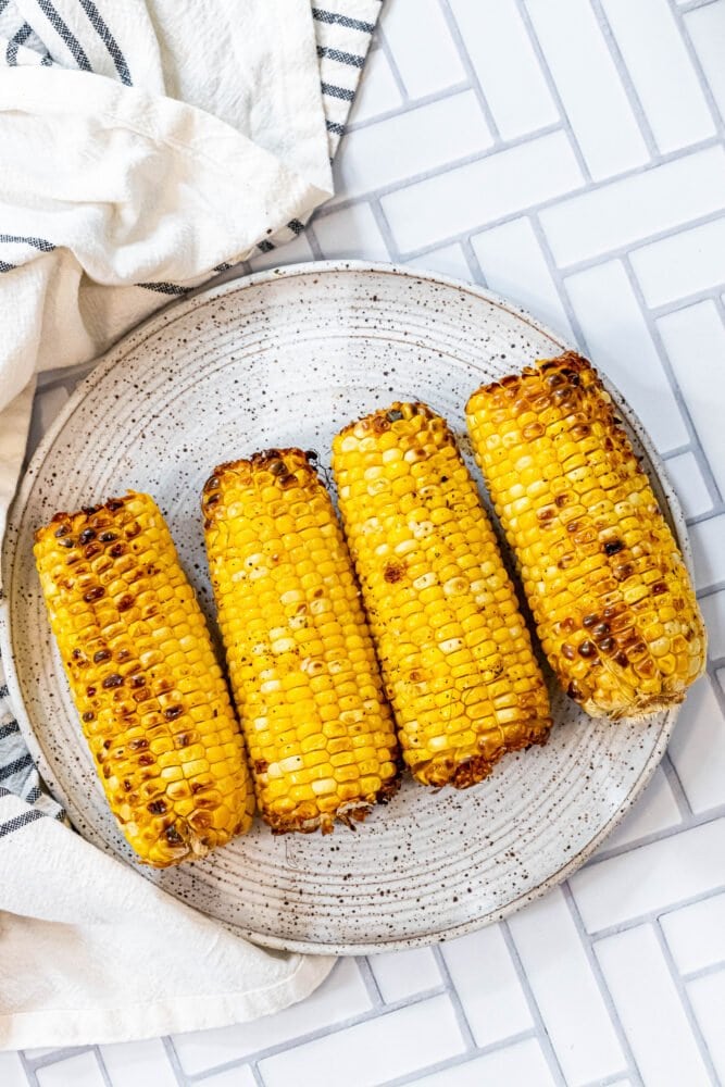 picture of grilled corn on a white plate