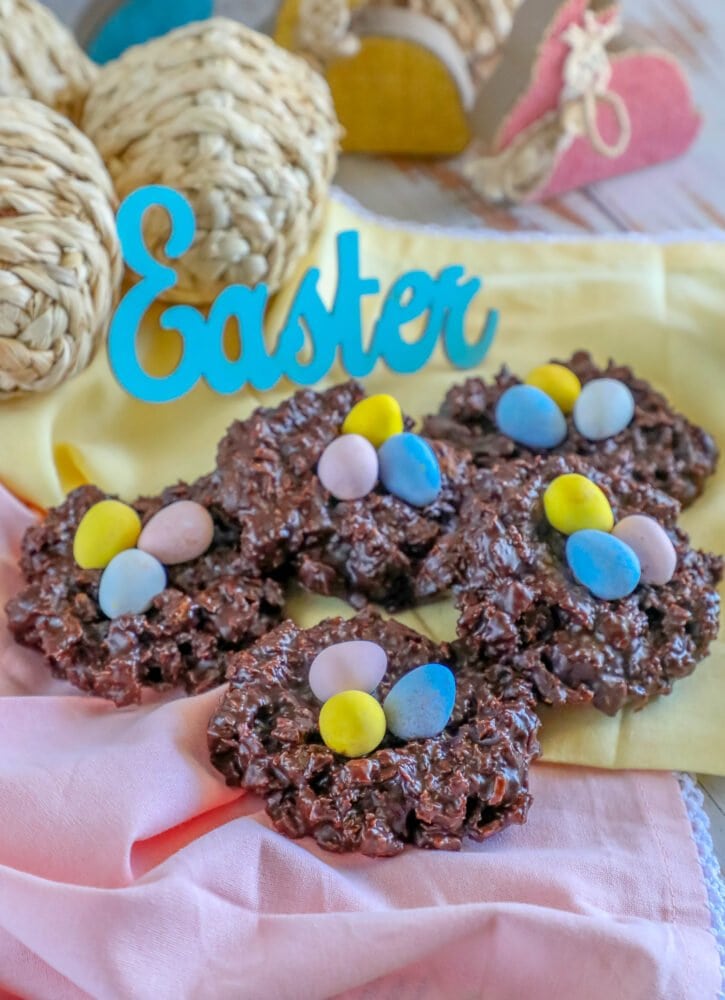 picture of chocolate cookies shaped like a birds nest with candy eggs on top 