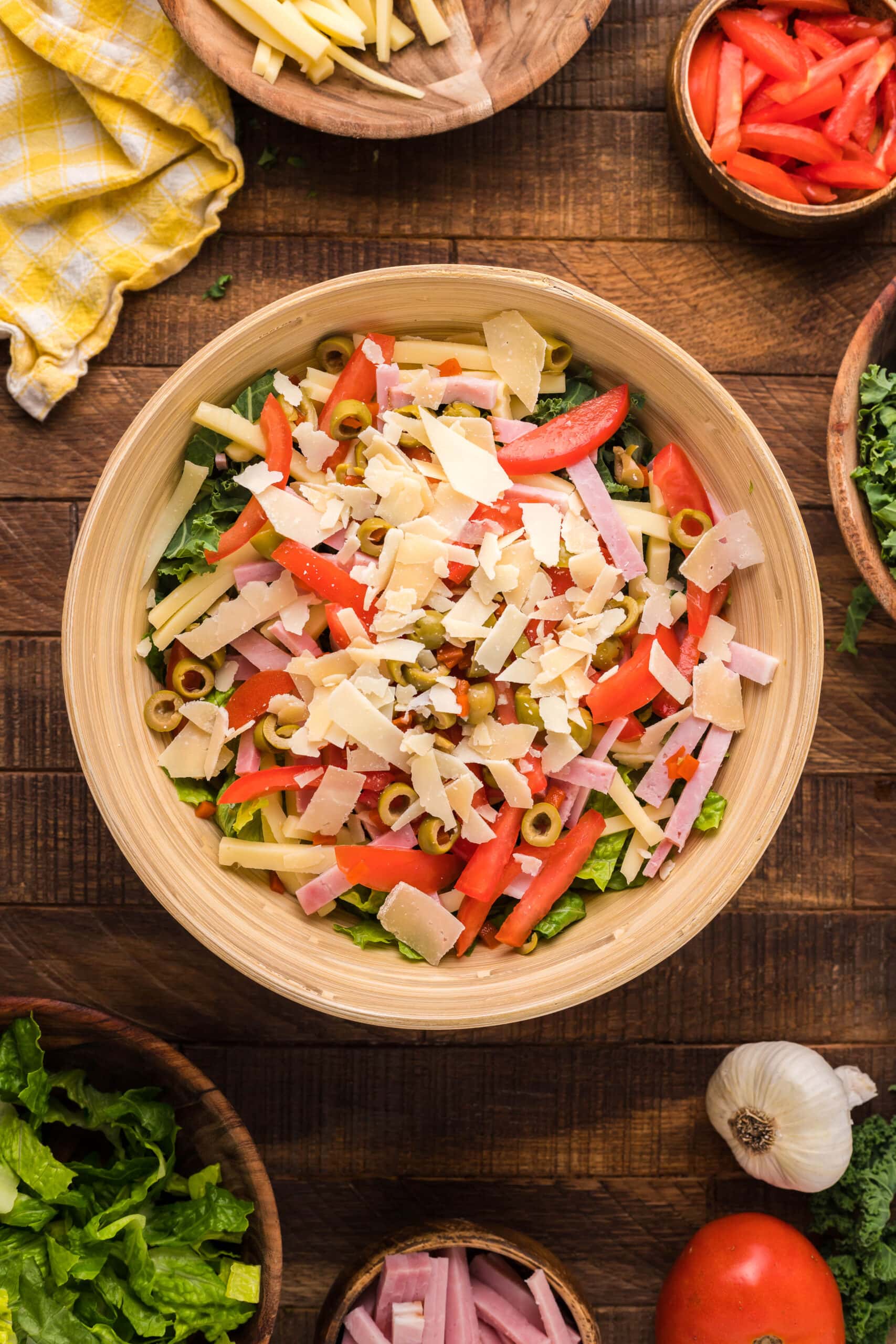 A bowl of Kale Salad on a wooden table.
