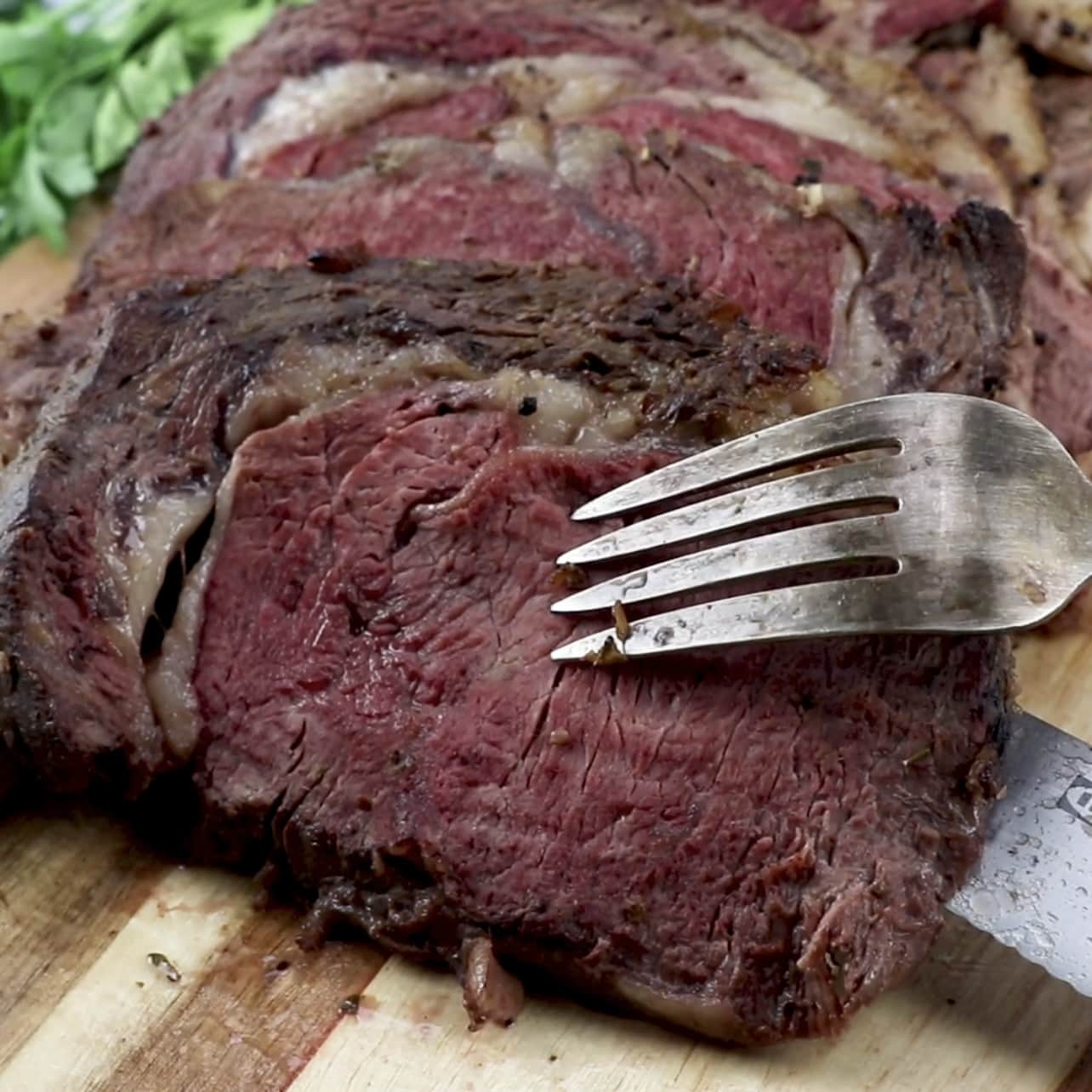 picture of fork holding slice of ribeye roast